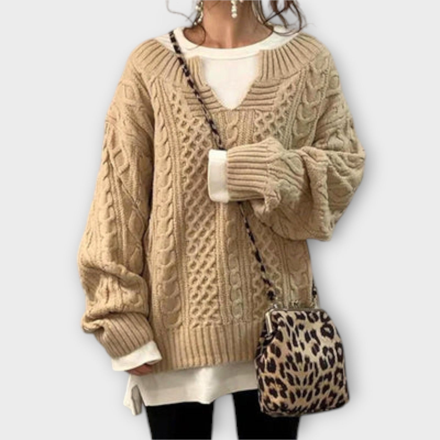 Oversized knitted sweater with cable pattern